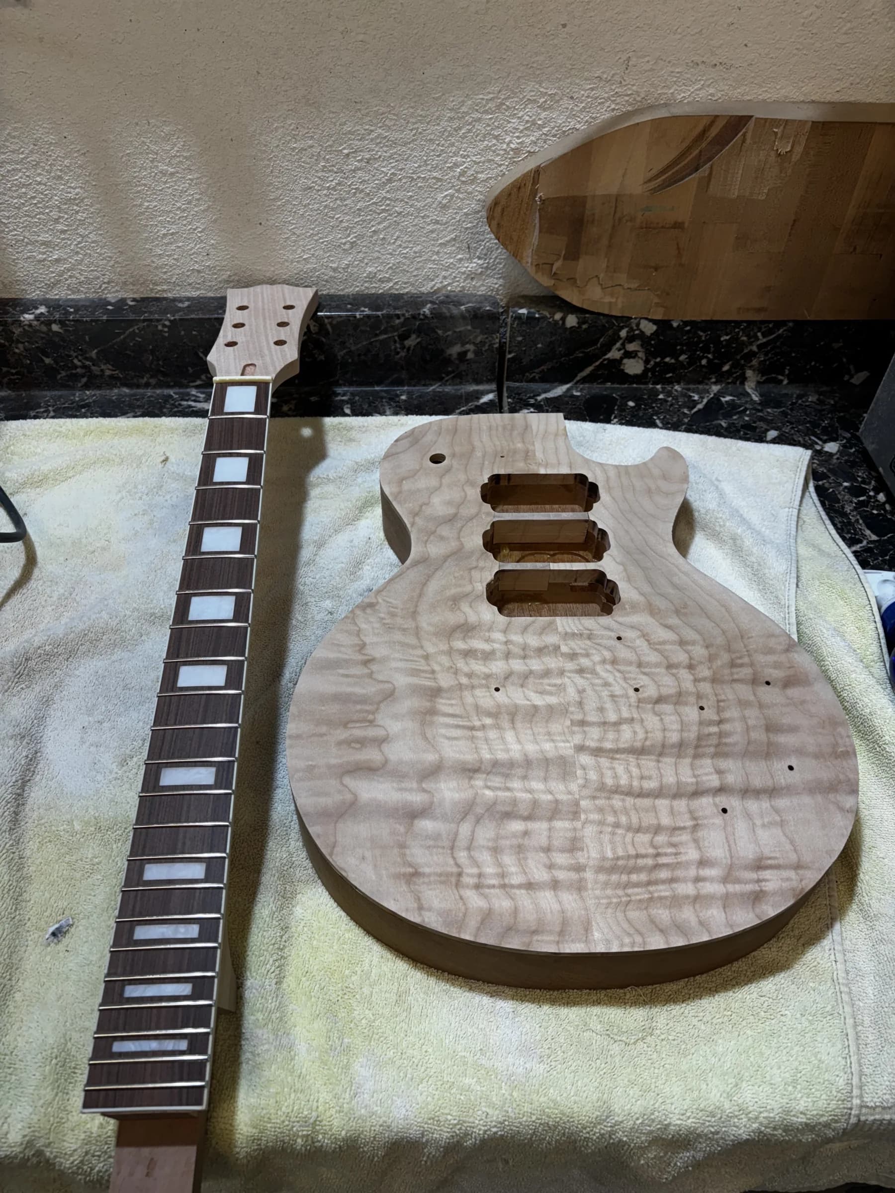 SJR guitar body and neck components arranged together
