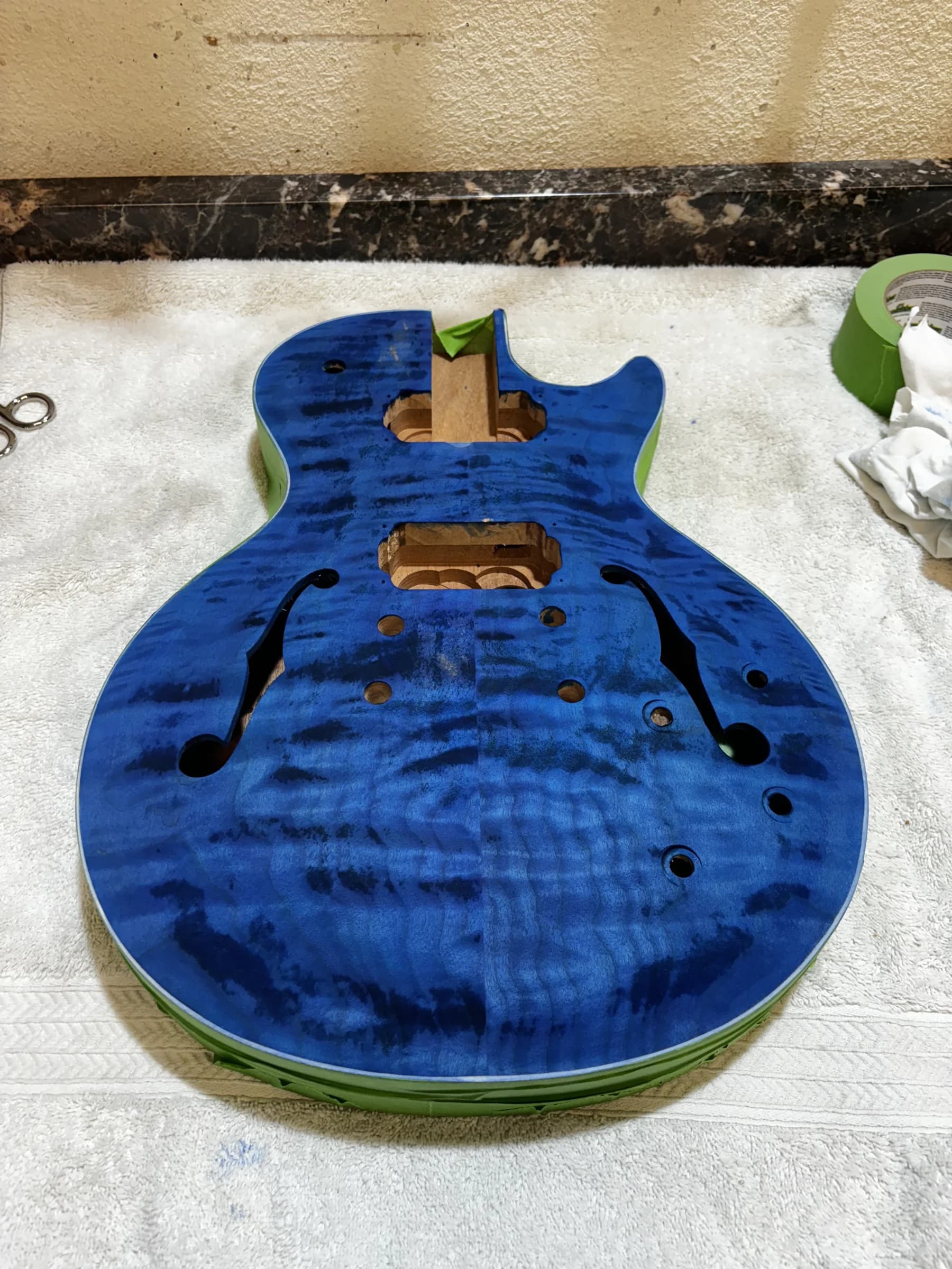 Blue-stained semi-hollow guitar body during finishing