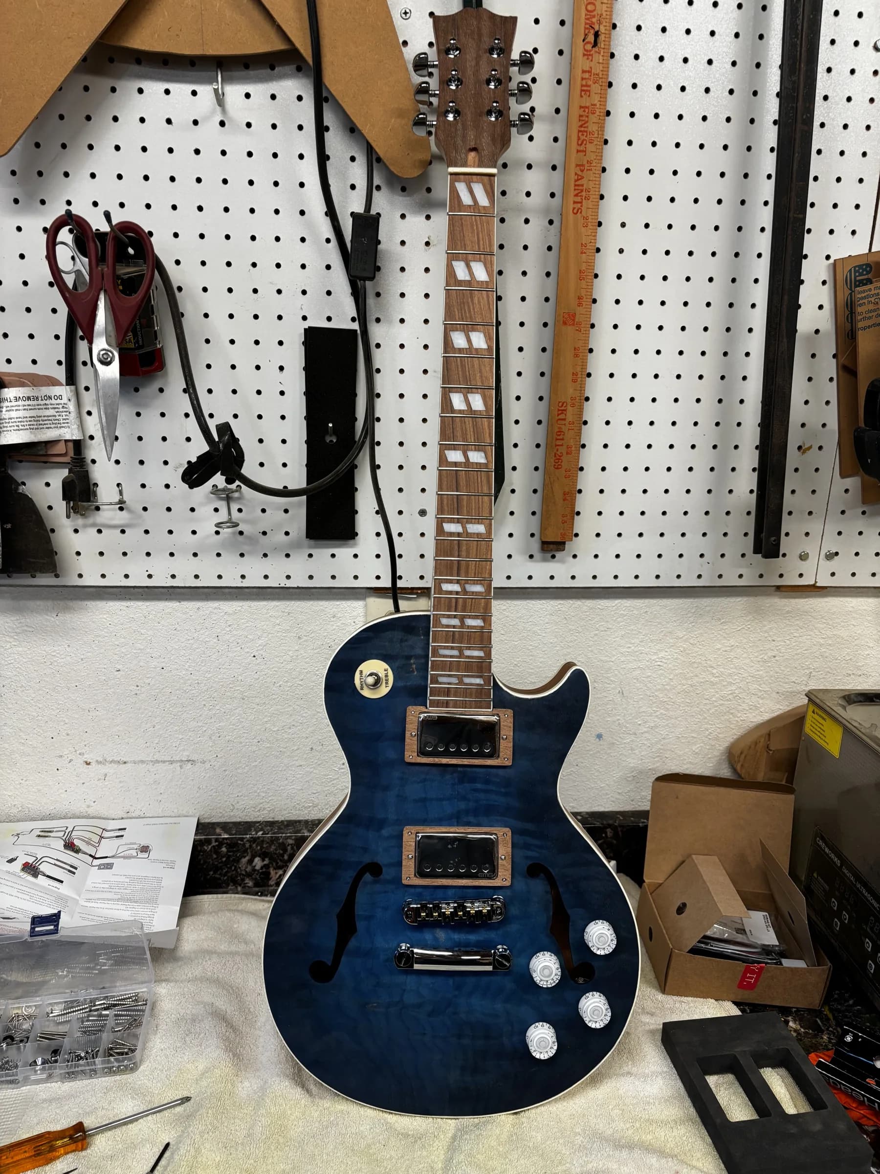 Blue semi-hollow SJR guitar during assembly