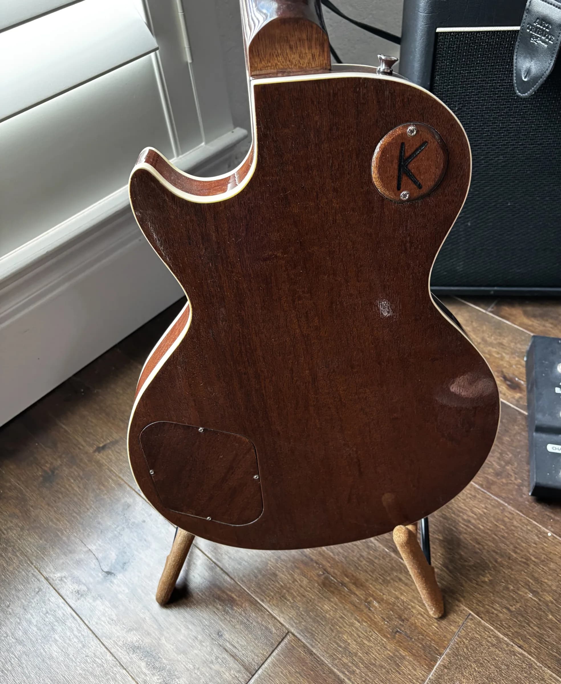 Dark wood back and binding of a blue SJR guitar