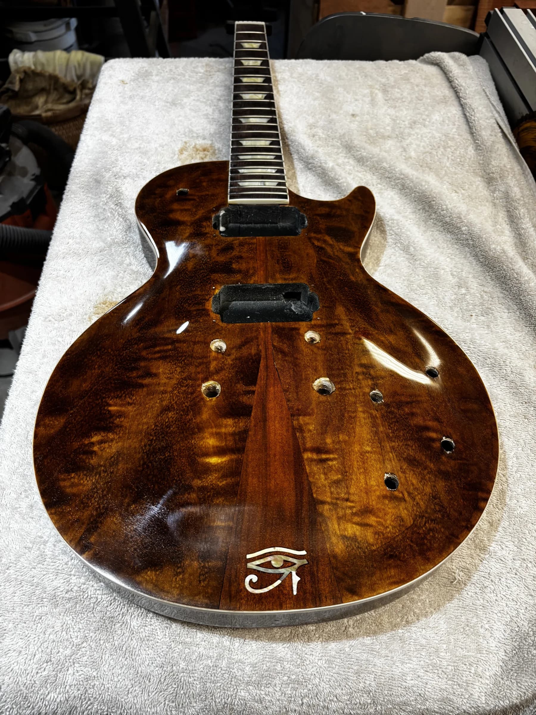 Glossy brown guitar body during assembly