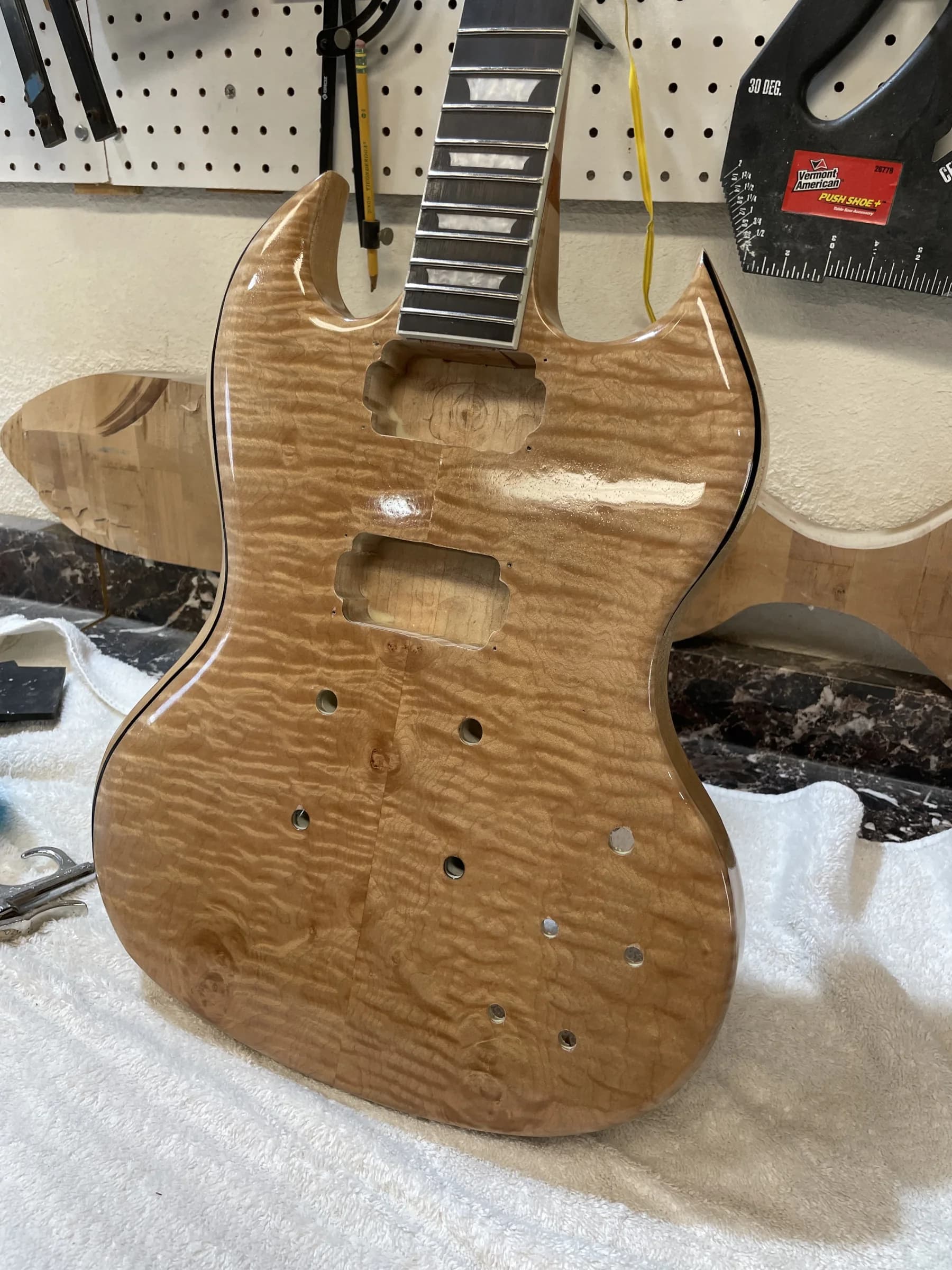 Figured double-cut SJR guitar body during assembly