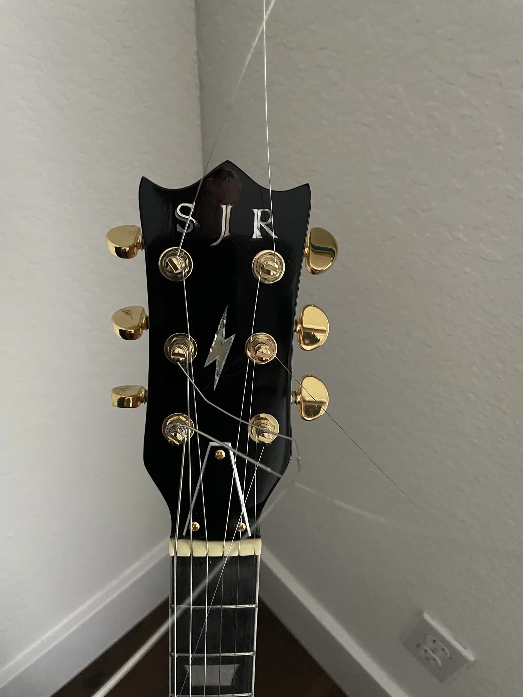 Dark SJR headstock with gold tuning hardware