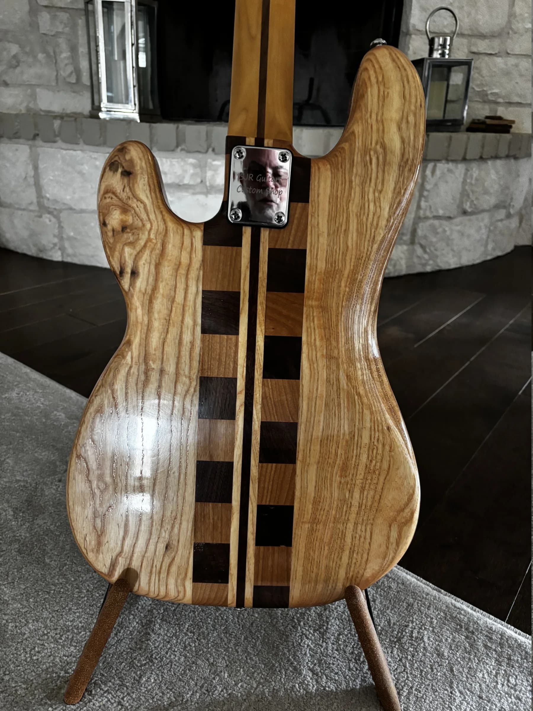 Rear-body view of a natural striped SJR bass with laminated center detail and an SJR neck plate