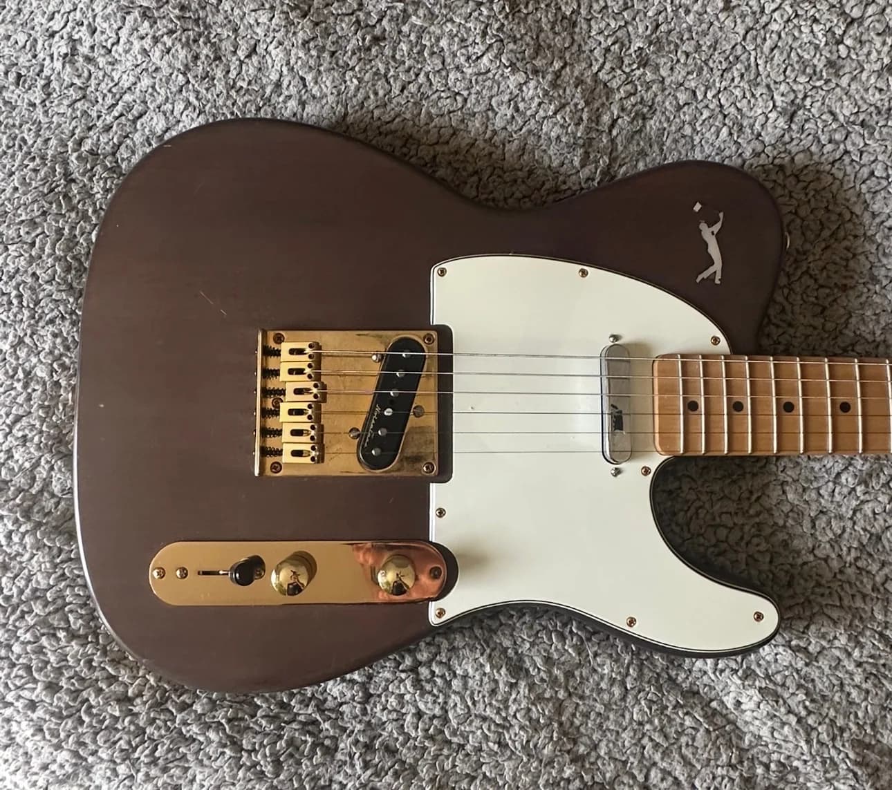 Brown personalized custom-guitar body with cream pickguard and metal hardware